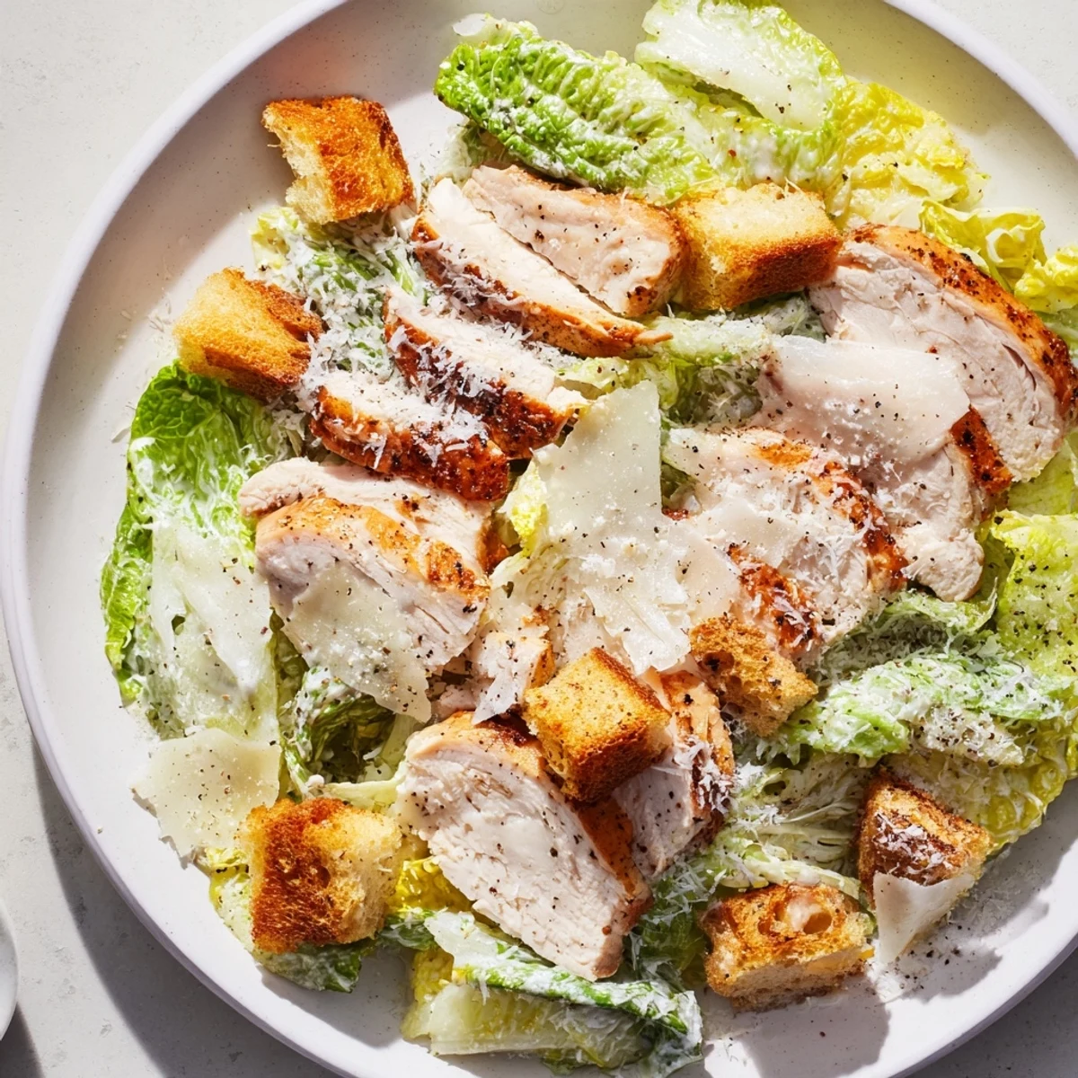 Grilled chicken Caesar salad with homemade croutons on crisp romaine, topped with Parmesan and creamy dressing.