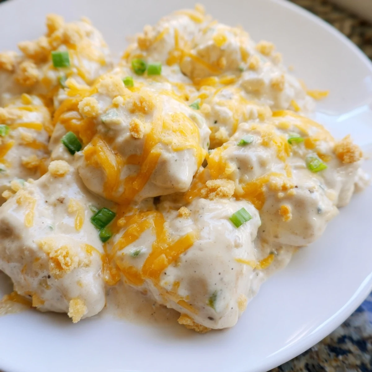 Tender Sour Cream and Onion Chicken fresh from the oven, garnished with extra chopped green onions for flavor.