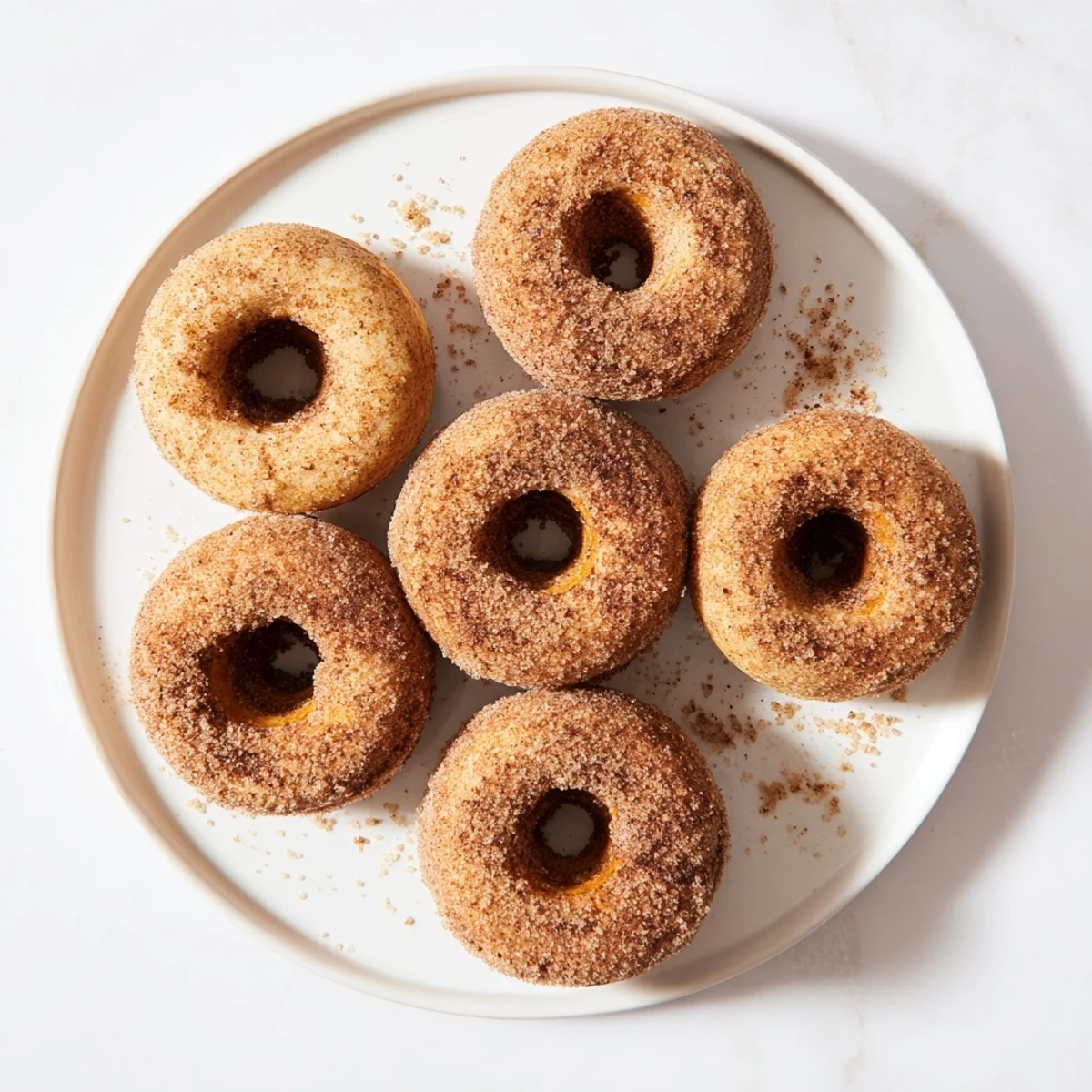 Warm Delicious Baked Cinnamon Sugar Donuts You Can’t Resist are dusted with spiced sugar, perfect for a cozy breakfast.