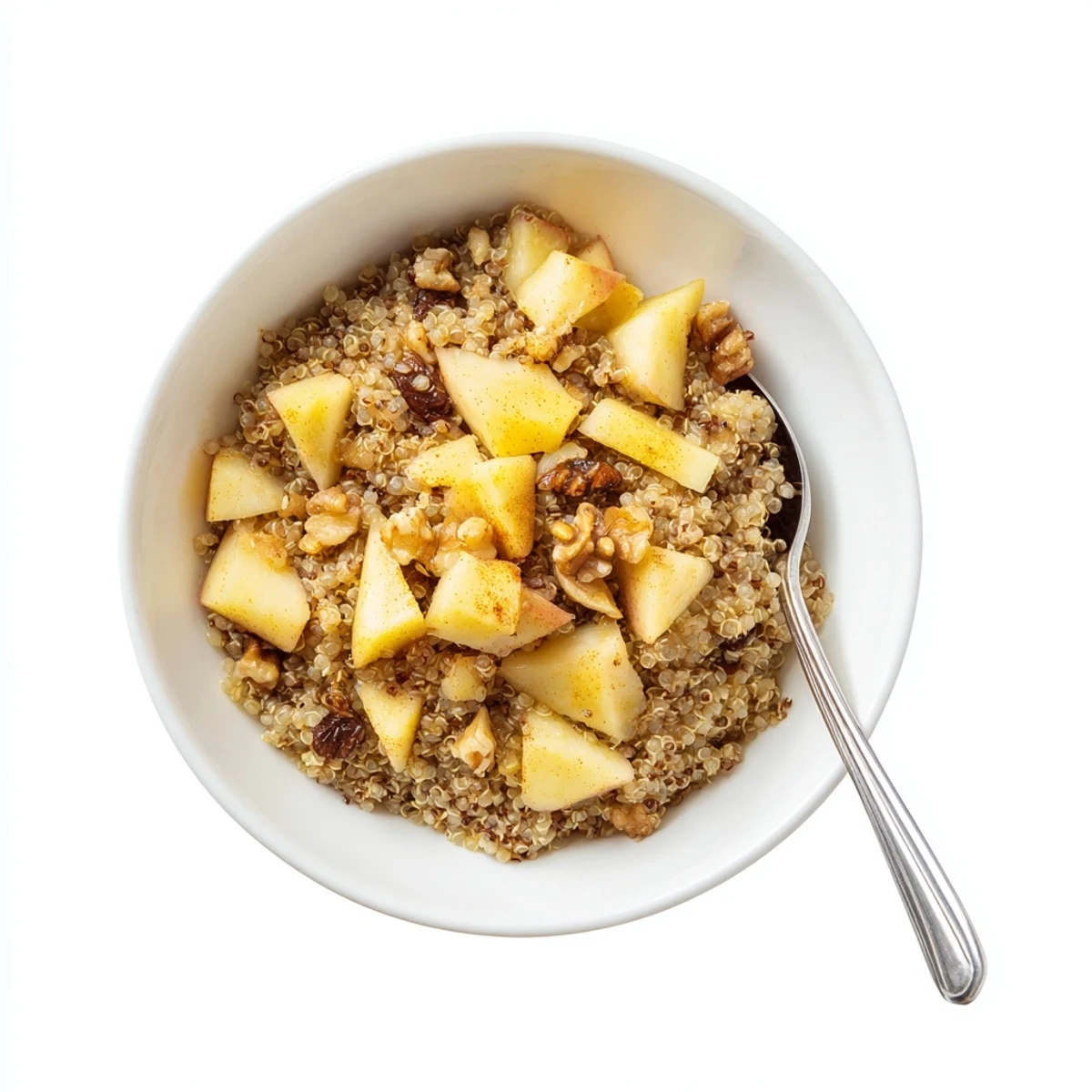 A warm bowl of Healthy Quinoa Apple Breakfast topped with chopped walnuts and fresh apple slices.
