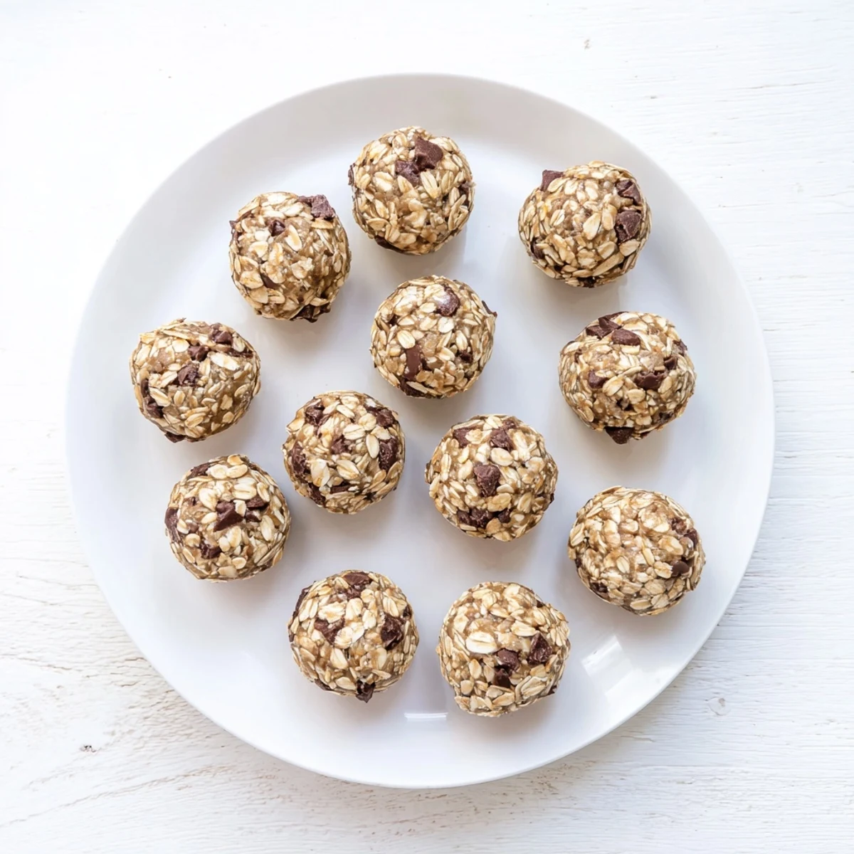 These mint chocolate chip protein balls are refrigerated for a firm texture, great for dessert.