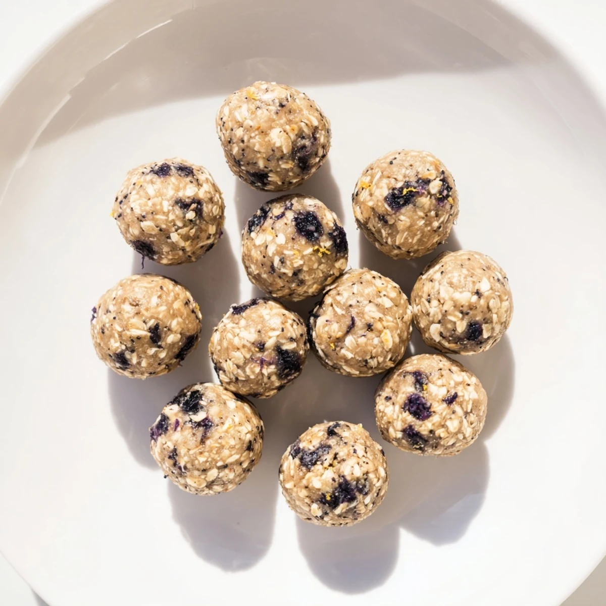 These gluten-free Blueberry Cheesecake Protein Bites offer a creamy texture and vibrant blue hue.