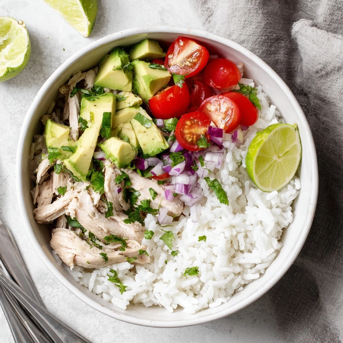 Sliced honey lime glazed chicken served over steamed rice with buttery avocado and red onion toppings