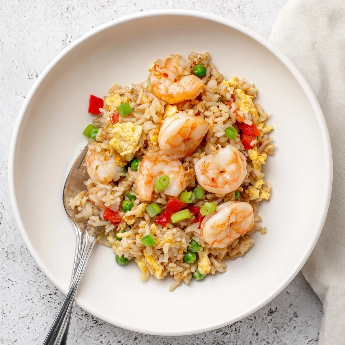 Succulent garlic butter prawns served over fragrant Asian fried rice drizzled with sweet chilli sauce