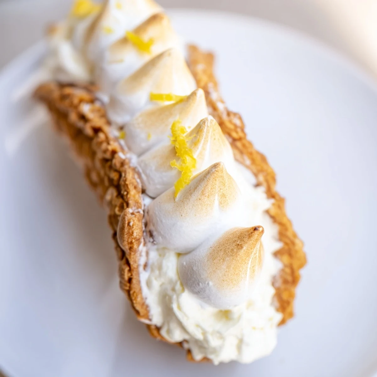 Golden toasted meringue crowns these Easy Lemon Meringue Cannoli filled with zesty cream