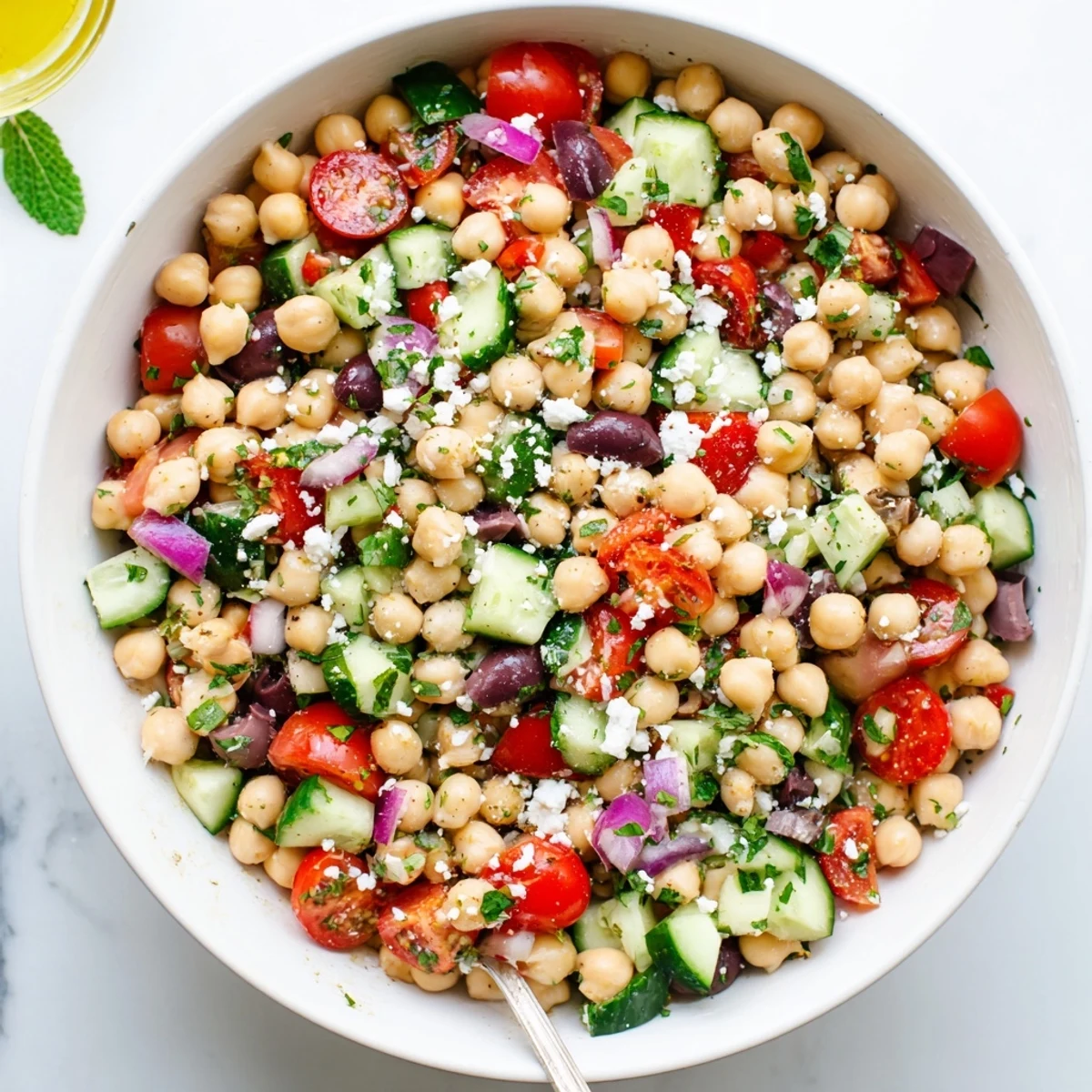 Fresh Mediterranean chickpea salad featuring chickpeas, cherry tomatoes, cucumber, and tangy feta