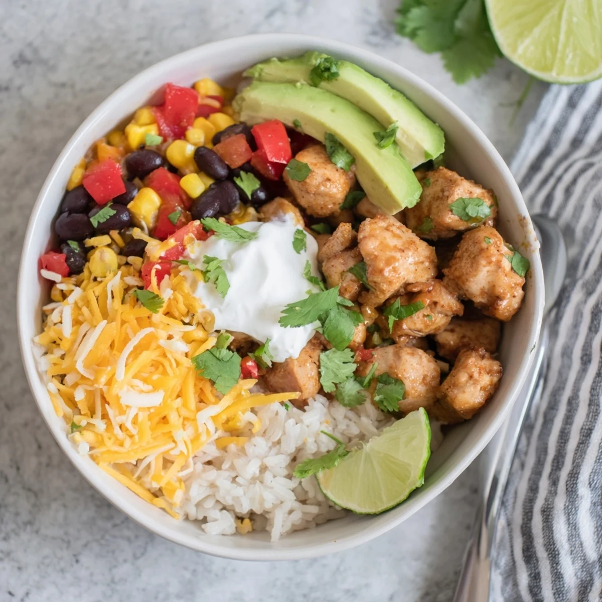 Hearty chicken burrito bowl featuring rice, beans, corn and tender spiced chicken in one pot