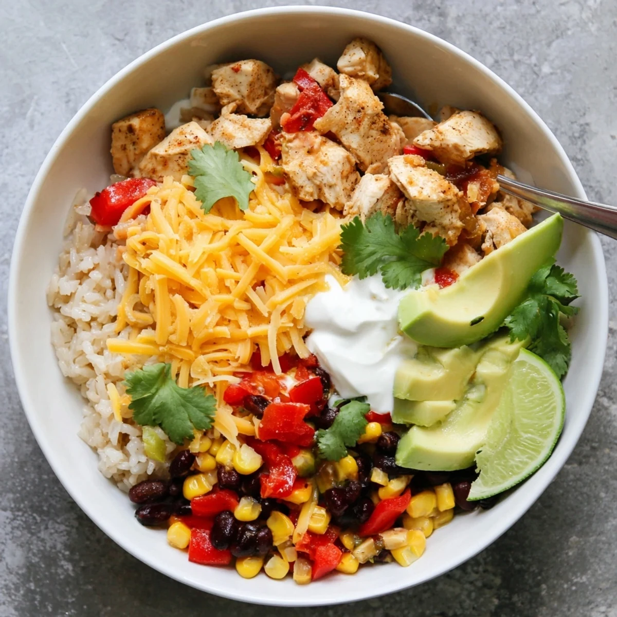 Served Mexican style Instant Pot chicken burrito bowls with fresh toppings and zesty seasonings