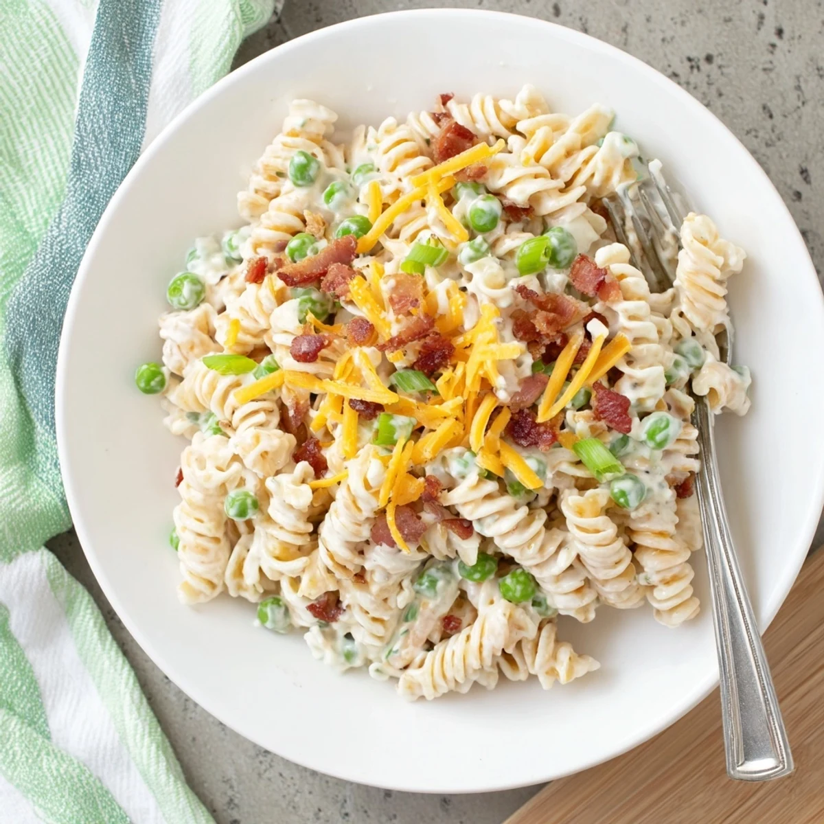 Creamy crack pasta salad loaded with crispy bacon, cheddar cheese, and green onions in a ranch dressing