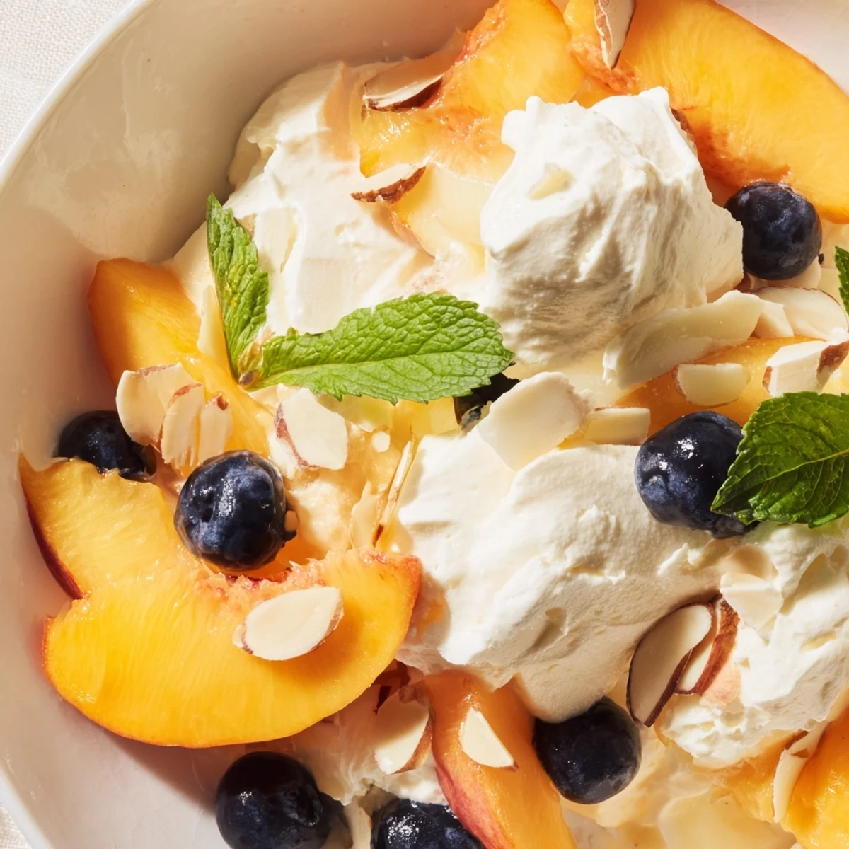 Sliced ripe peaches layered with fluffy whipped cream in this refreshing Peaches and Cream Salad