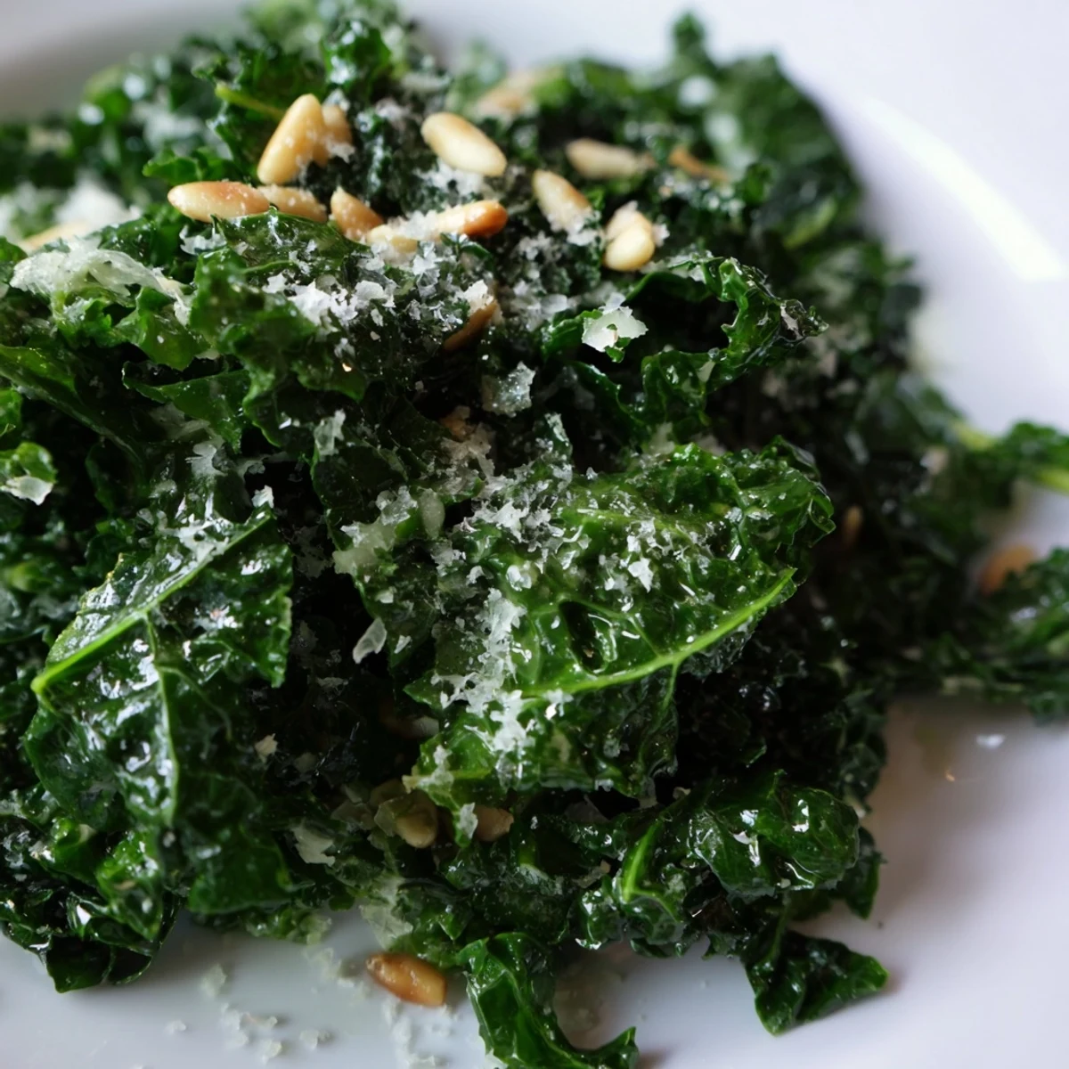 Fresh garlic lemon Parmesan kale salad in a wooden bowl with shaved cheese