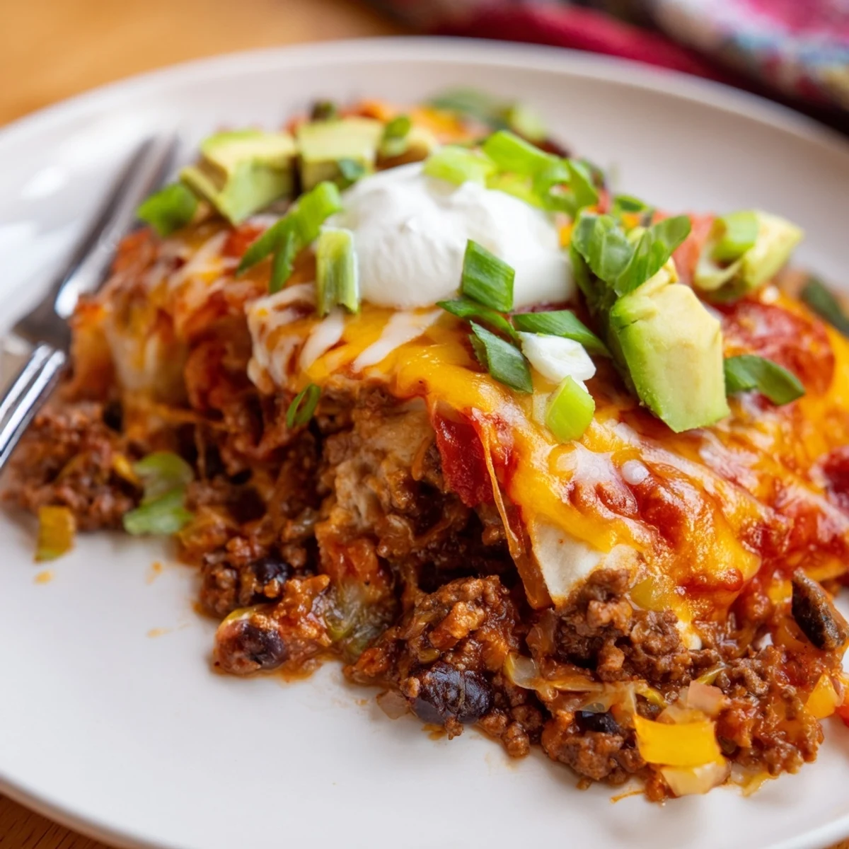 Steam rising from Beef Skillet Enchiladas layered with corn tortillas and smoky spices