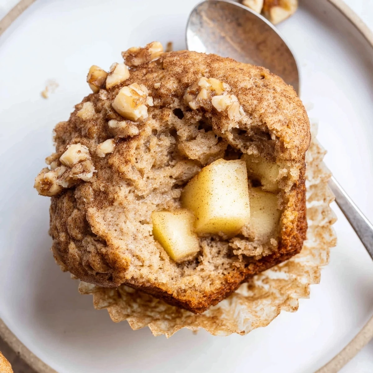Stacked Healthy Apple Cinnamon Greek Yogurt Muffins with juicy apple pieces and cinnamon