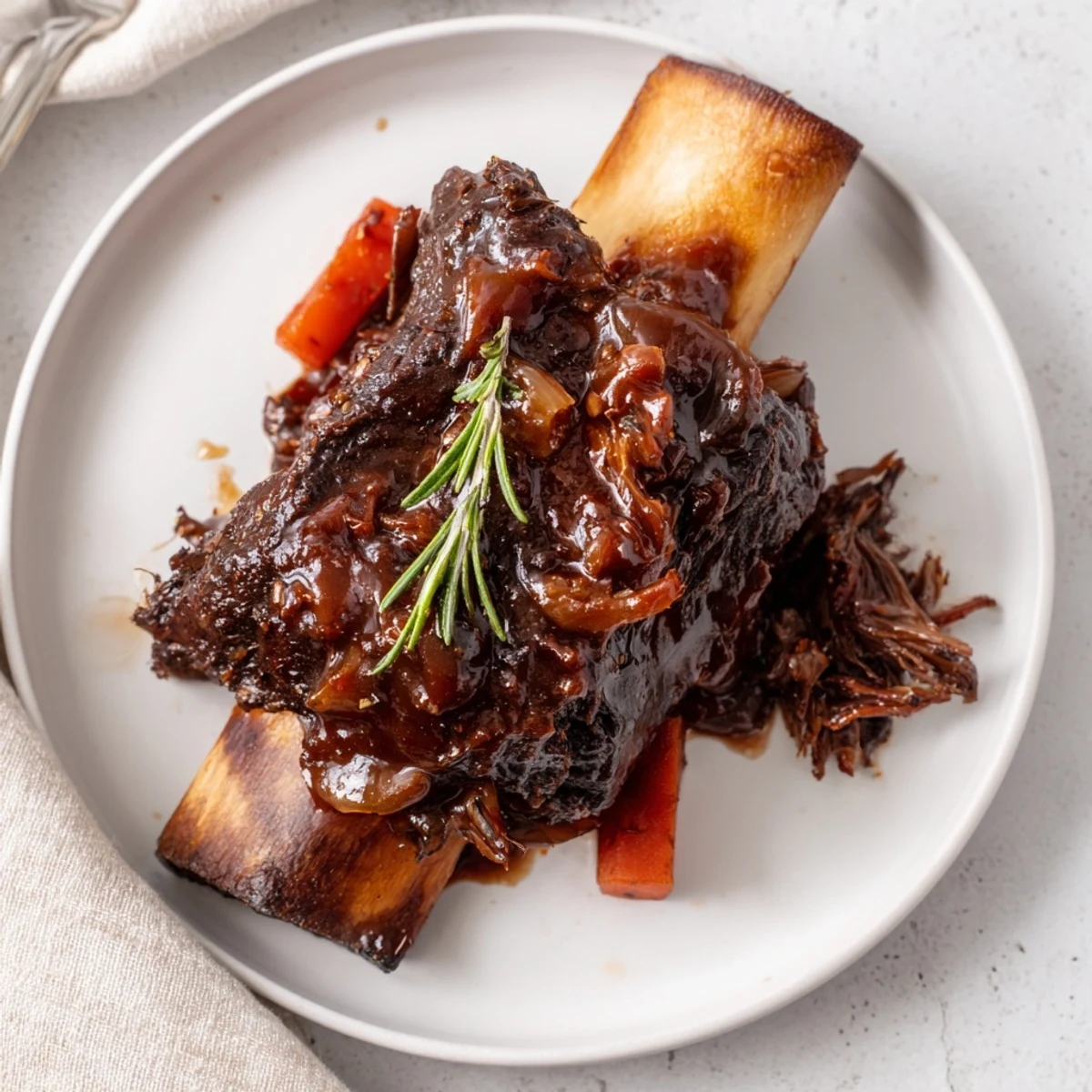 Glistening Slow Cooker Beef Short Ribs in rich sauce over mashed potatoes