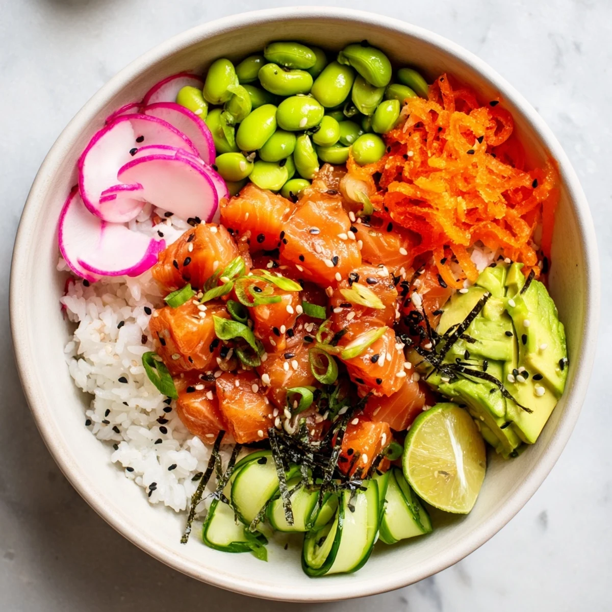 Fresh cubed salmon marinated in soy sesame sauce atop fluffy rice with avocado slices