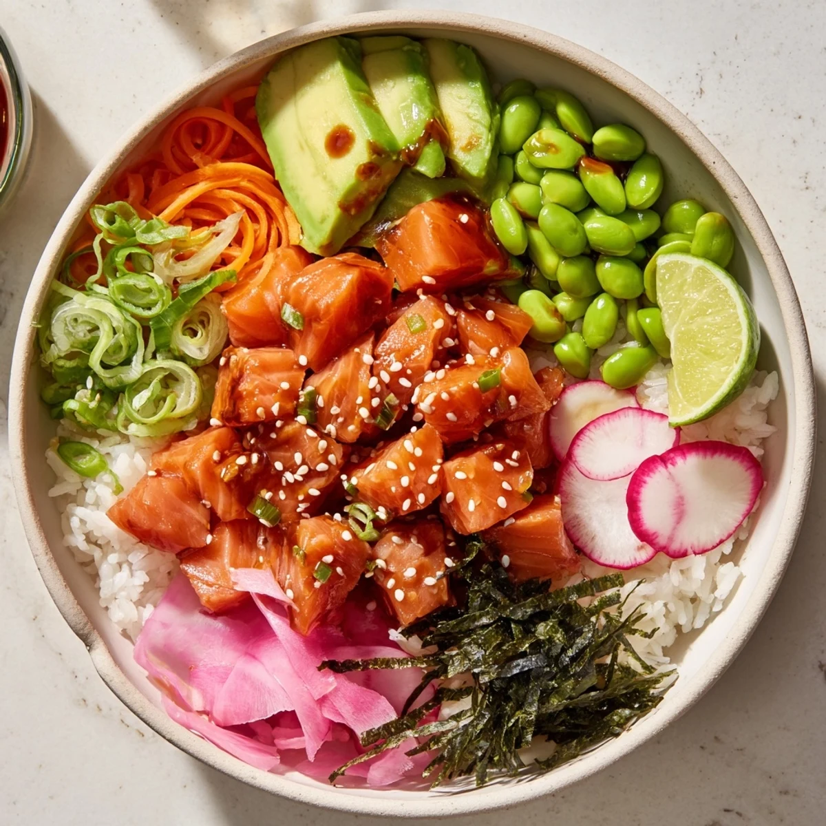 Hawaiian-style poke bowl featuring raw salmon, creamy avocado, crisp cucumber, and tangy pickled ginger