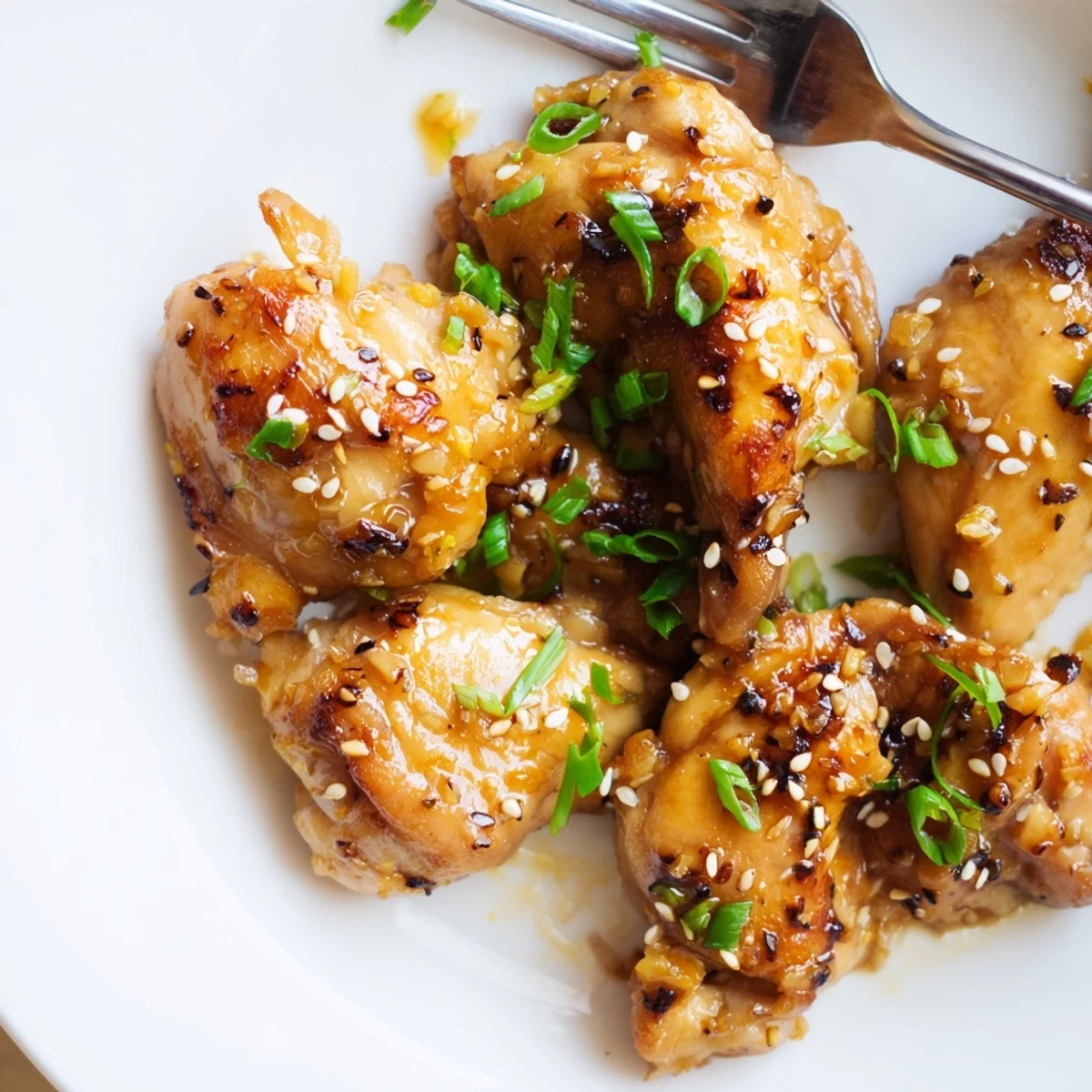 Juicy pan-seared garlic black pepper chicken served over steaming white rice with vegetables