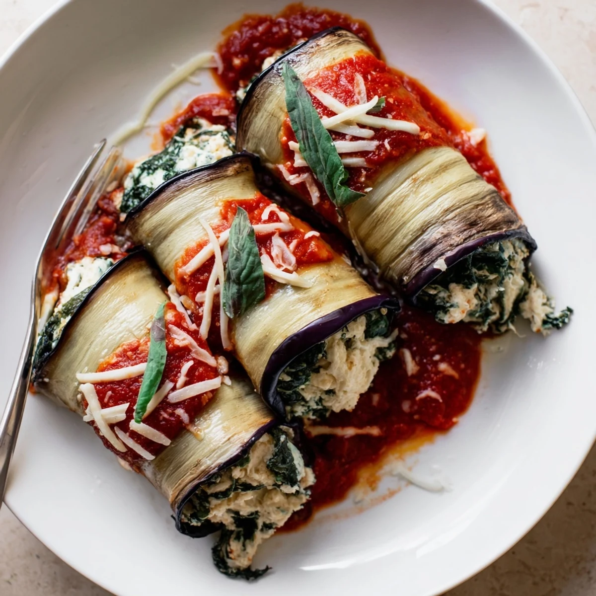 Creamy ricotta stuffed Healthy Eggplant Rollatini resting after baking, aroma of garlic