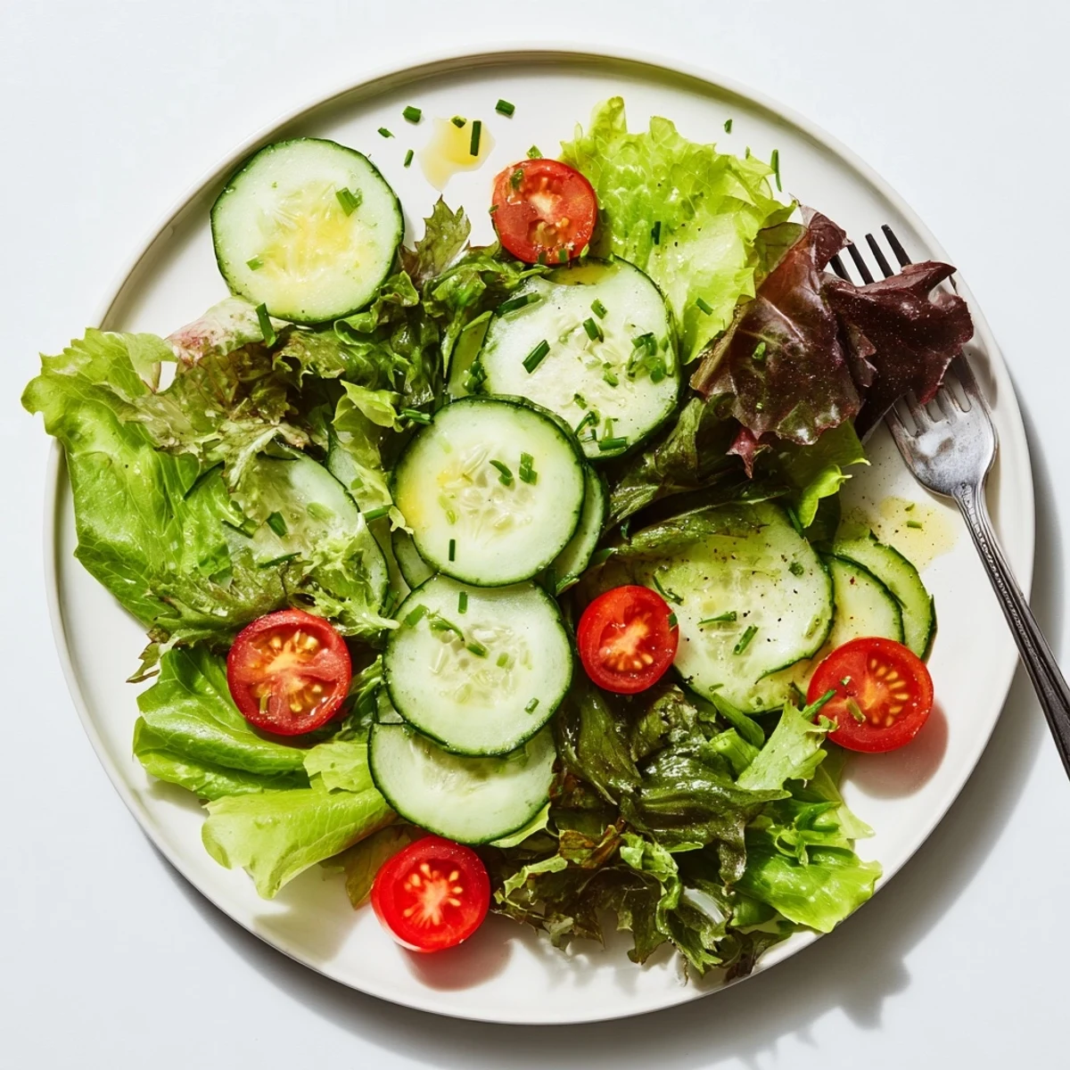 Bowl of Simple Green Salad Recipe, crunchy greens, halved cherry tomatoes, fresh herbs