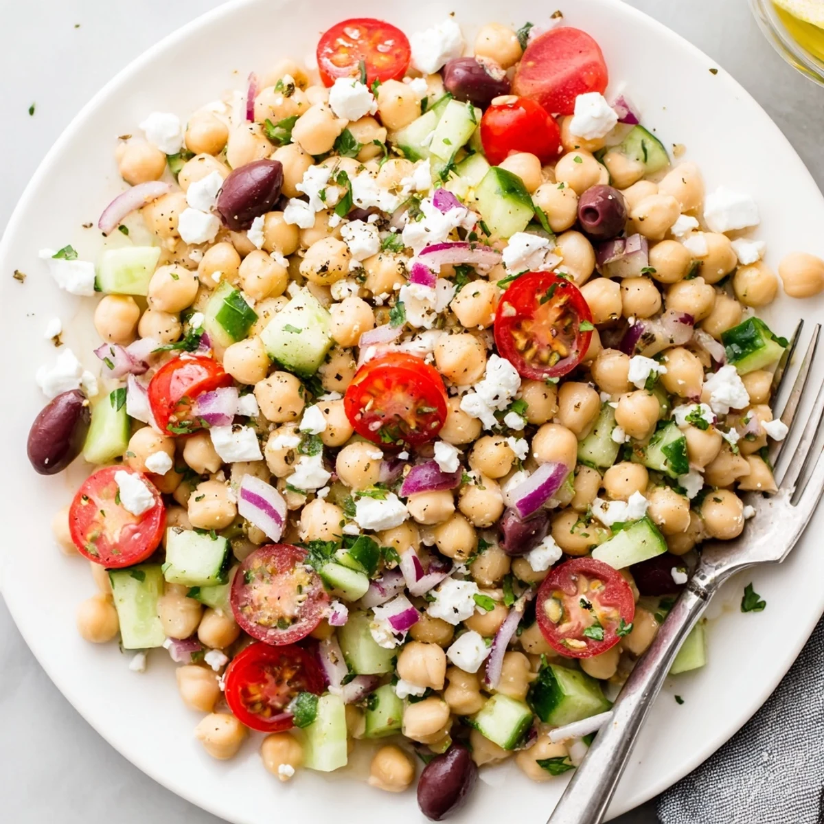 Homestyle salad piled high with olives, feta, and parsley — Mediterranean Chickpea Salad Recipe.