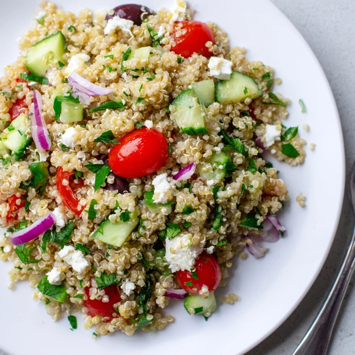 Greek Quinoa Salad Recipe: colorful tomatoes, cucumbers, feta, tossed with lemony dressing