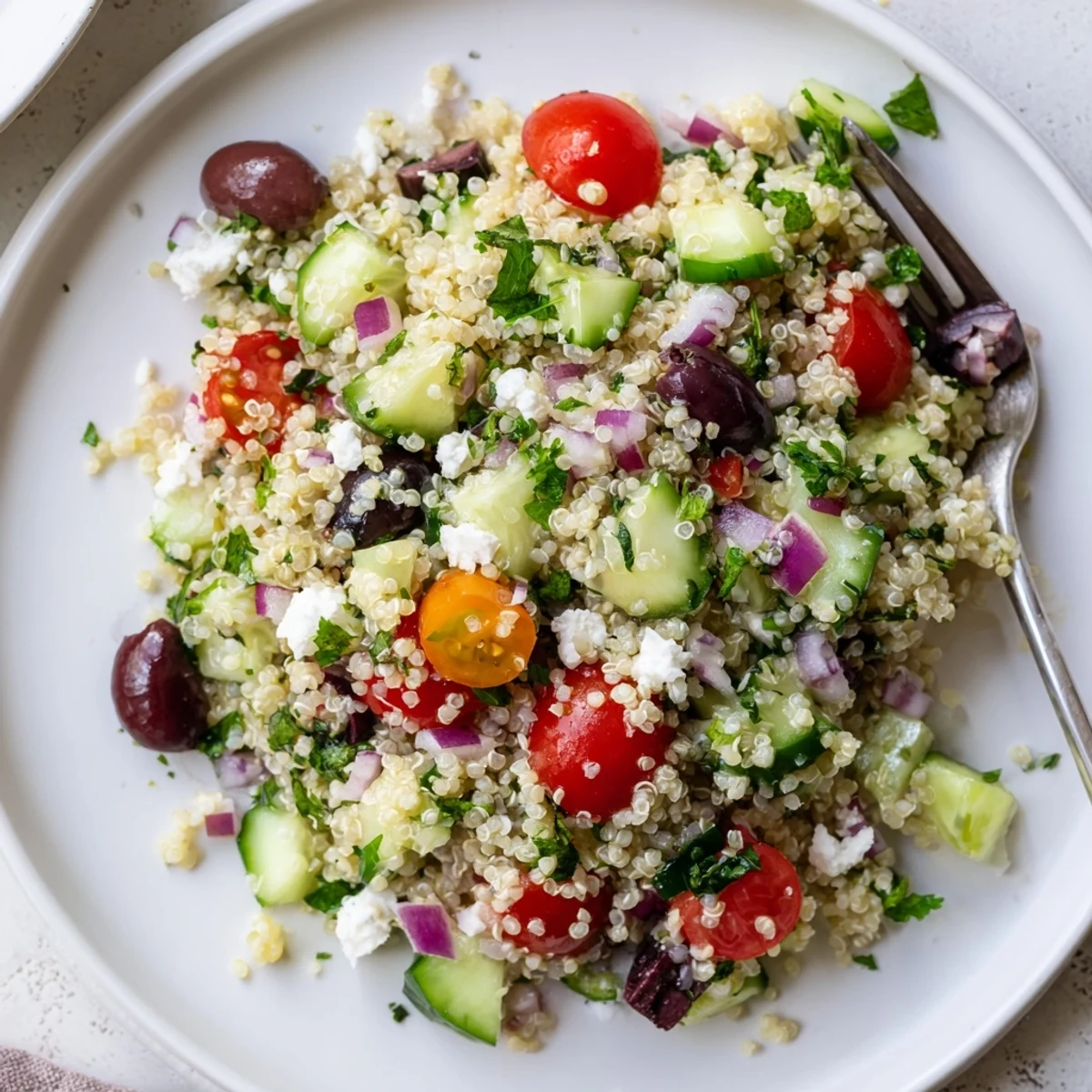 Weeknight favorite Greek Quinoa Salad Recipe featuring crunchy cucumbers and Kalamata olives