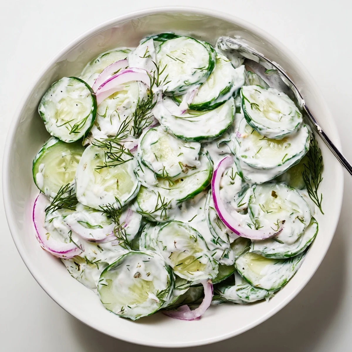 Chilled Greek Yogurt Cucumber Salad topped with mint, perfect beside grilled chicken
