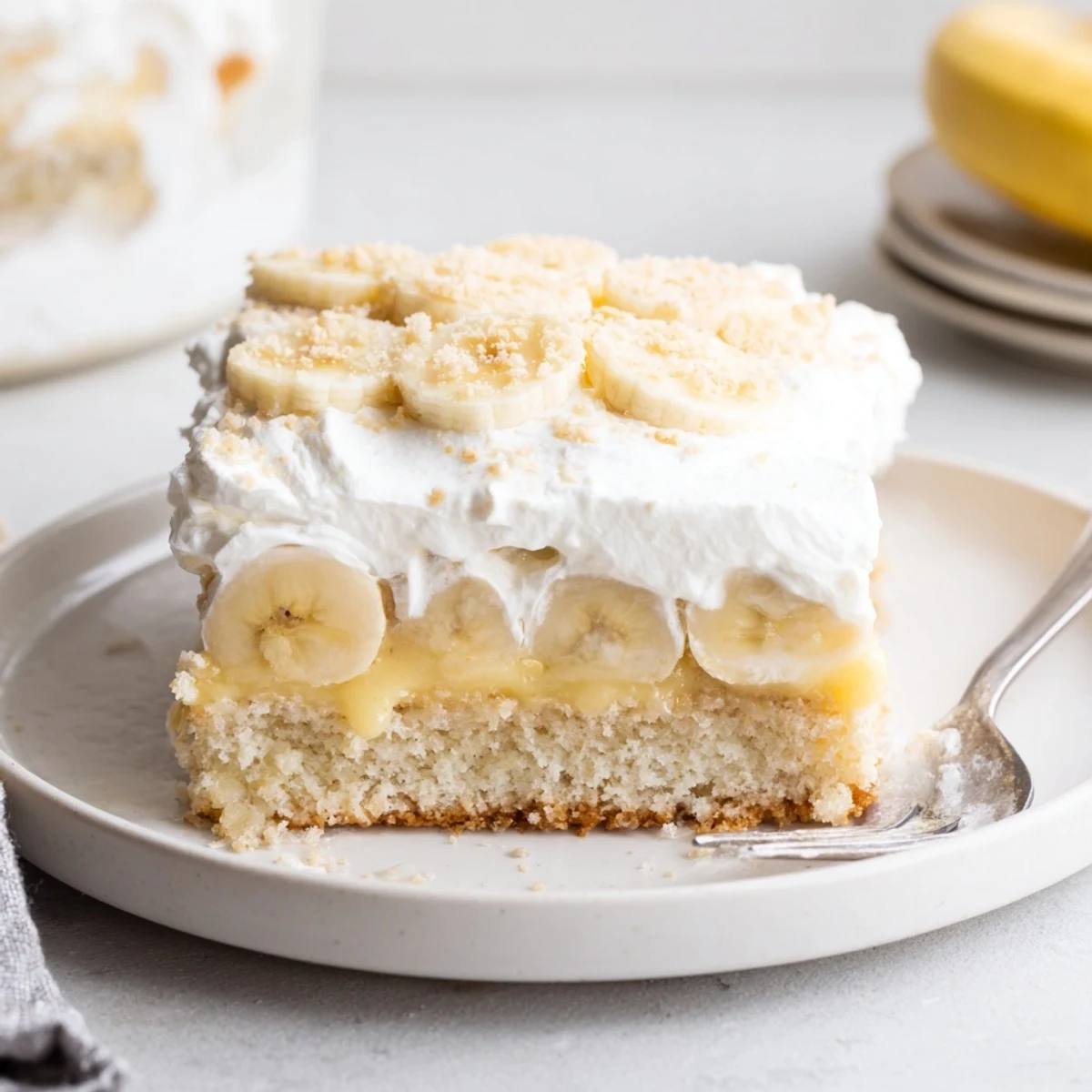 Banana Pudding Cake Recipe: moist layered cake with whipped cream and banana slices