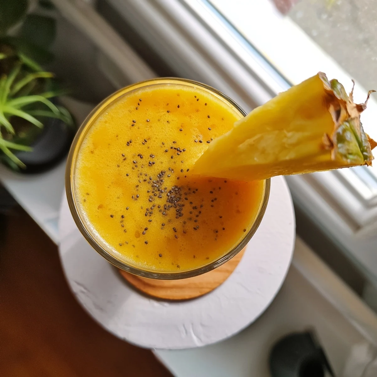 Vibrant yellow pineapple mango smoothie recipe blended with banana and coconut water for refreshing breakfast