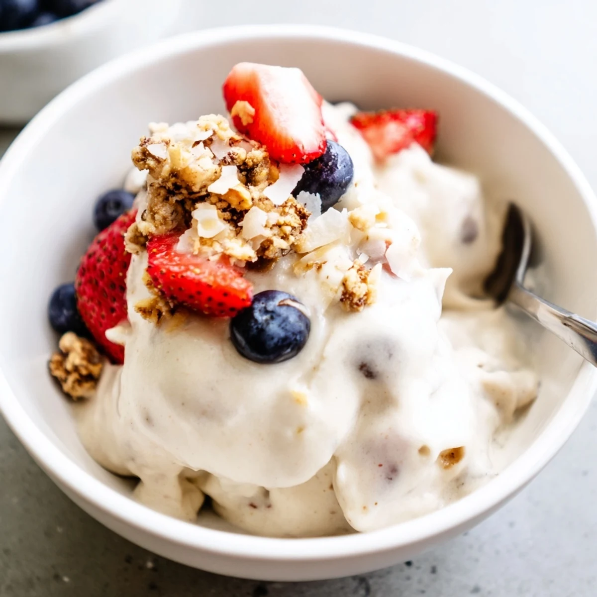 Homemade banana nice cream with swirls of cocoa powder served in a chilled dessert bowl
