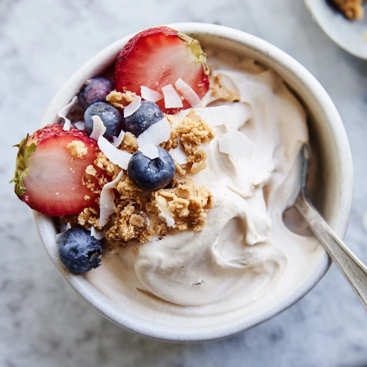 Dairy-free banana nice cream recipe showing smooth soft-serve texture in a glass with drizzled peanut butter