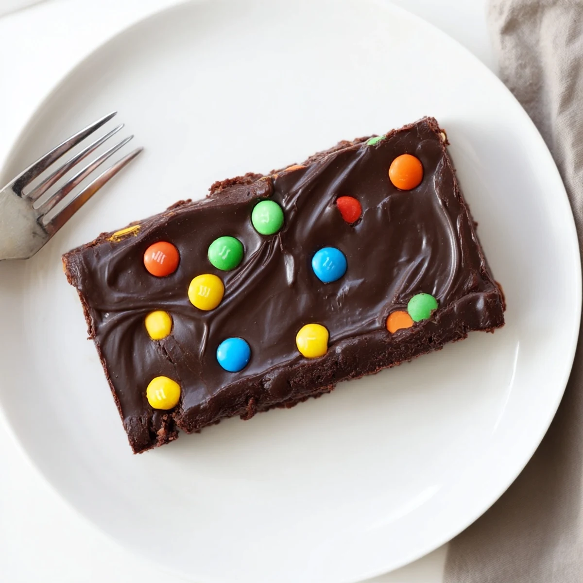 Slice of Gourmet Cosmic Brownies Bars chilled, dense fudgy center, colorful topping