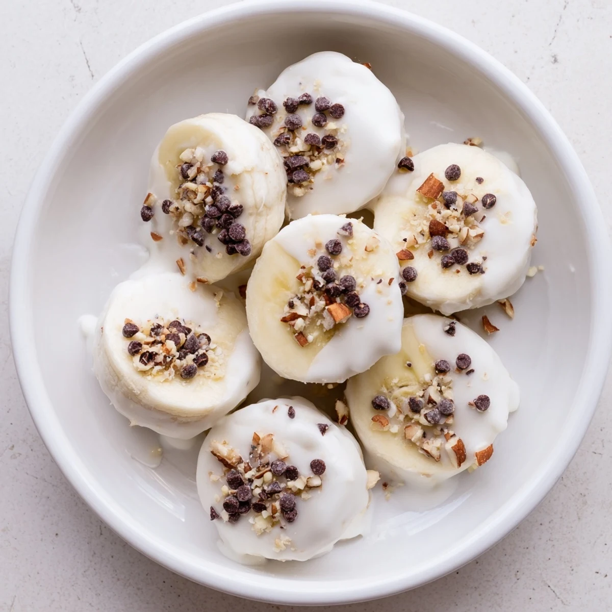 Stack of Frozen Banana Yogurt Bites on tray, chilled, ready for snacking  