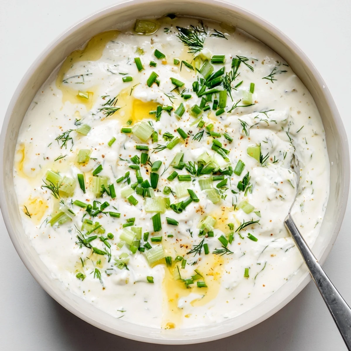 Tangy Hot Honey Ranch Dip with herb flecks, perfect for wings and veggies