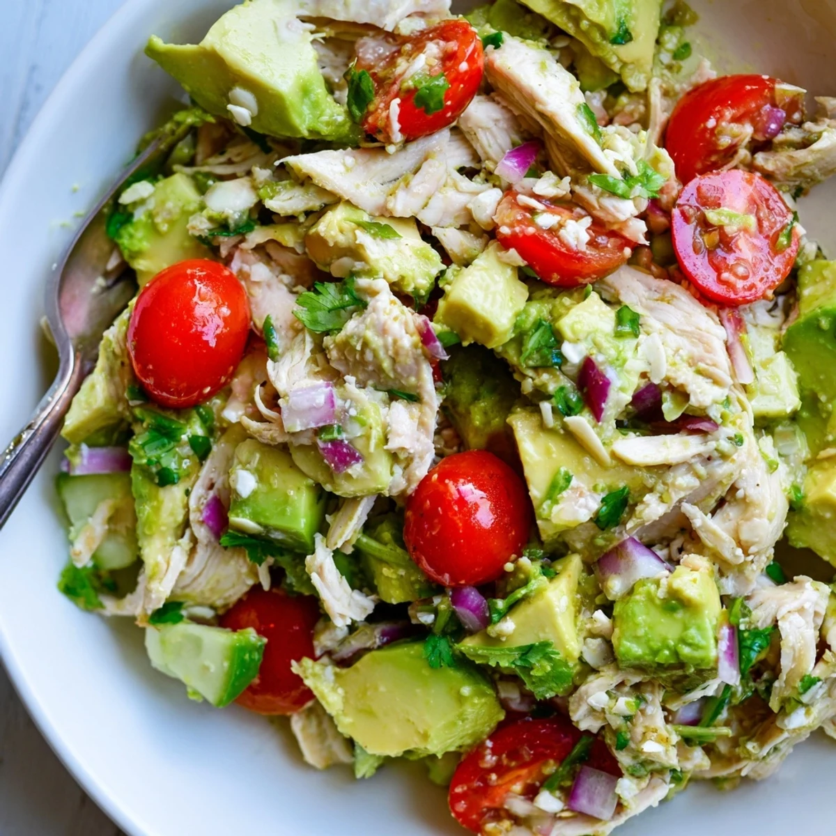 Avocado Chicken Salad featuring crunchy almonds, crumbled feta, cilantro and garlic zing.
