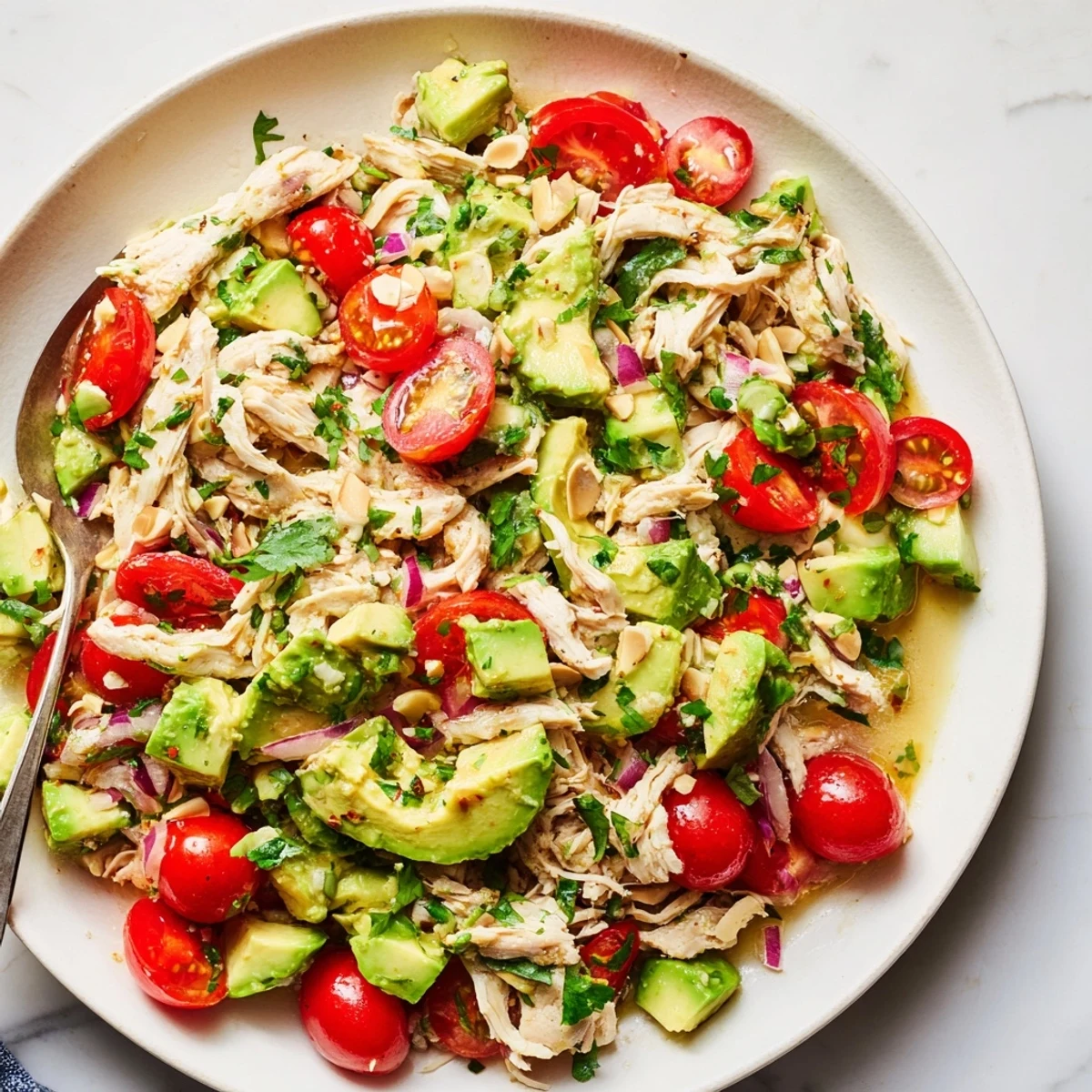 Avocado Chicken Salad tossed with cherry tomatoes, cucumber, perfect for picnics.
