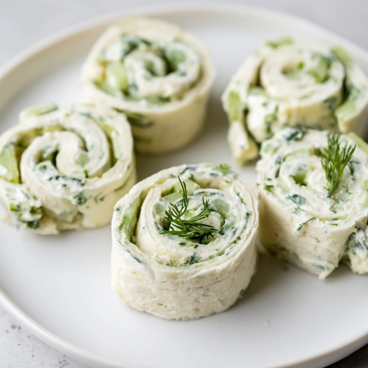 Chilled Cucumber And Dill Pinwheels sliced into spirals, crunchy cucumber bites.