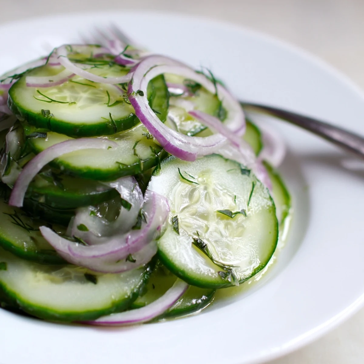 Cucumber Salad with thinly sliced cucumbers, tangy dressing, chilled and crisp.  