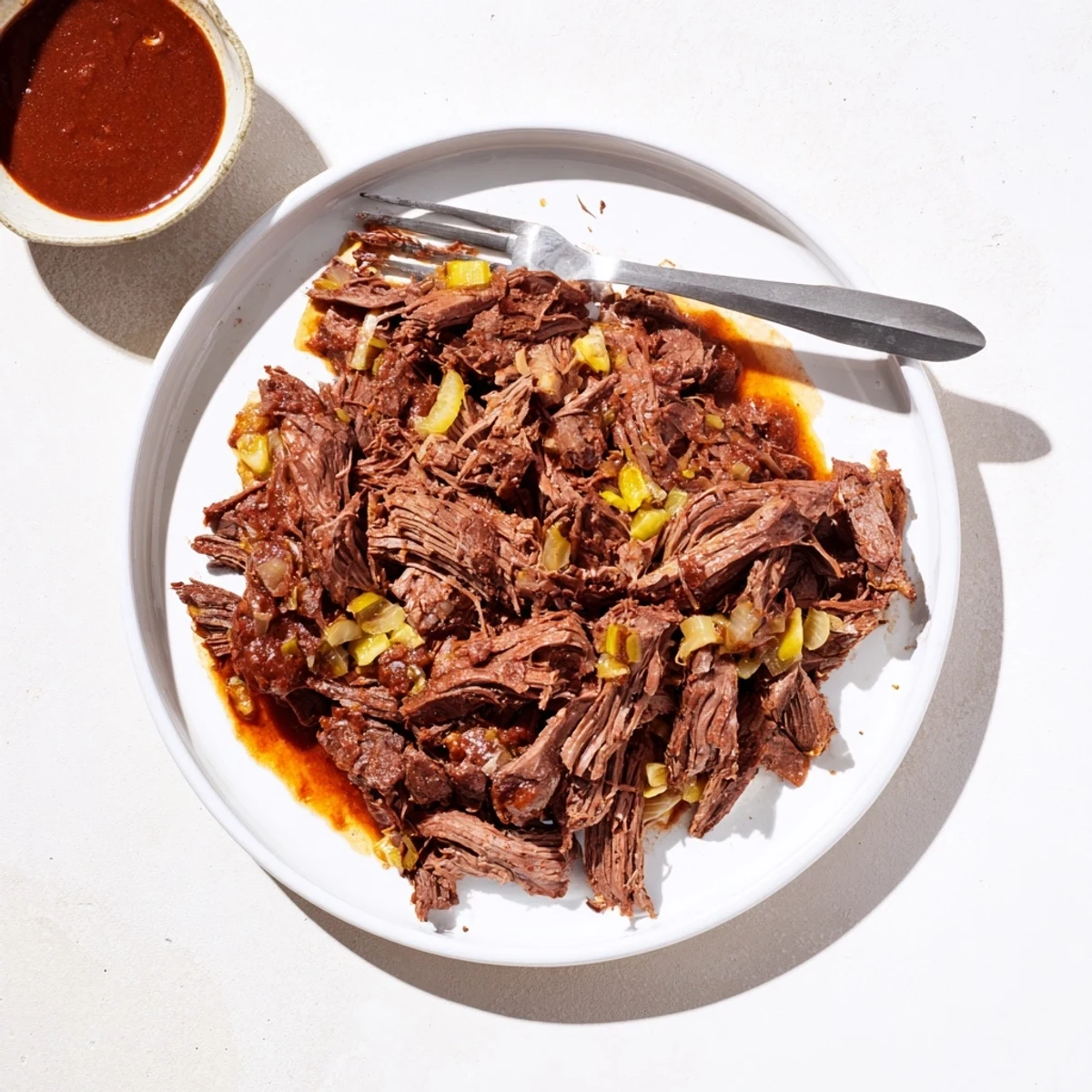 Tender slow cooker beef barbacoa piled high with fresh cilantro and diced onions