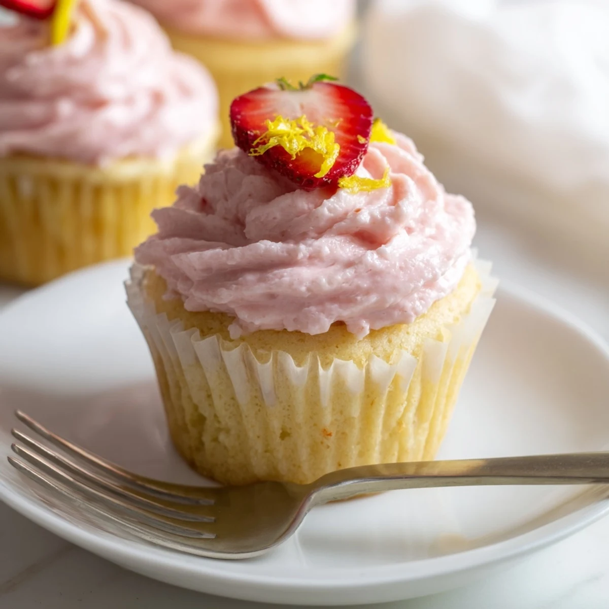 Light fluffy strawberry lemonade cupcakes with zesty lemon flavor and creamy swirled frosting
