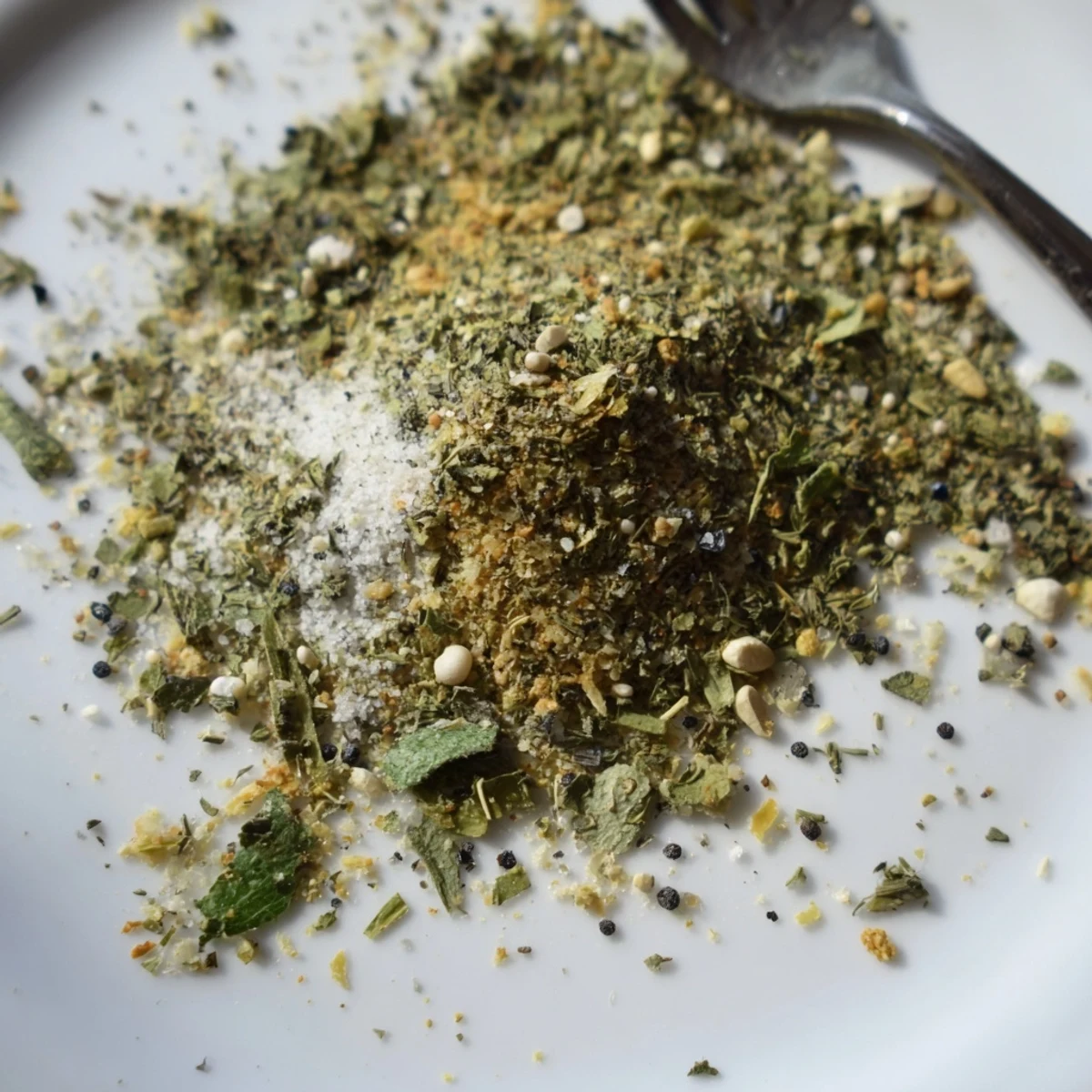 Vibrant green tzatziki seasoning blend sprinkled over grilled chicken and roasted vegetables for Greek-inspired flavor