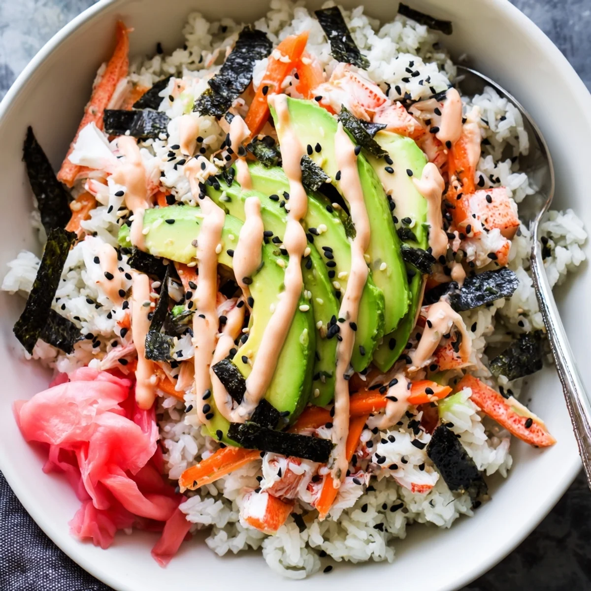 Chilled California Roll Sushi Bowls layered with cucumber ribbons, nori strips, sesame