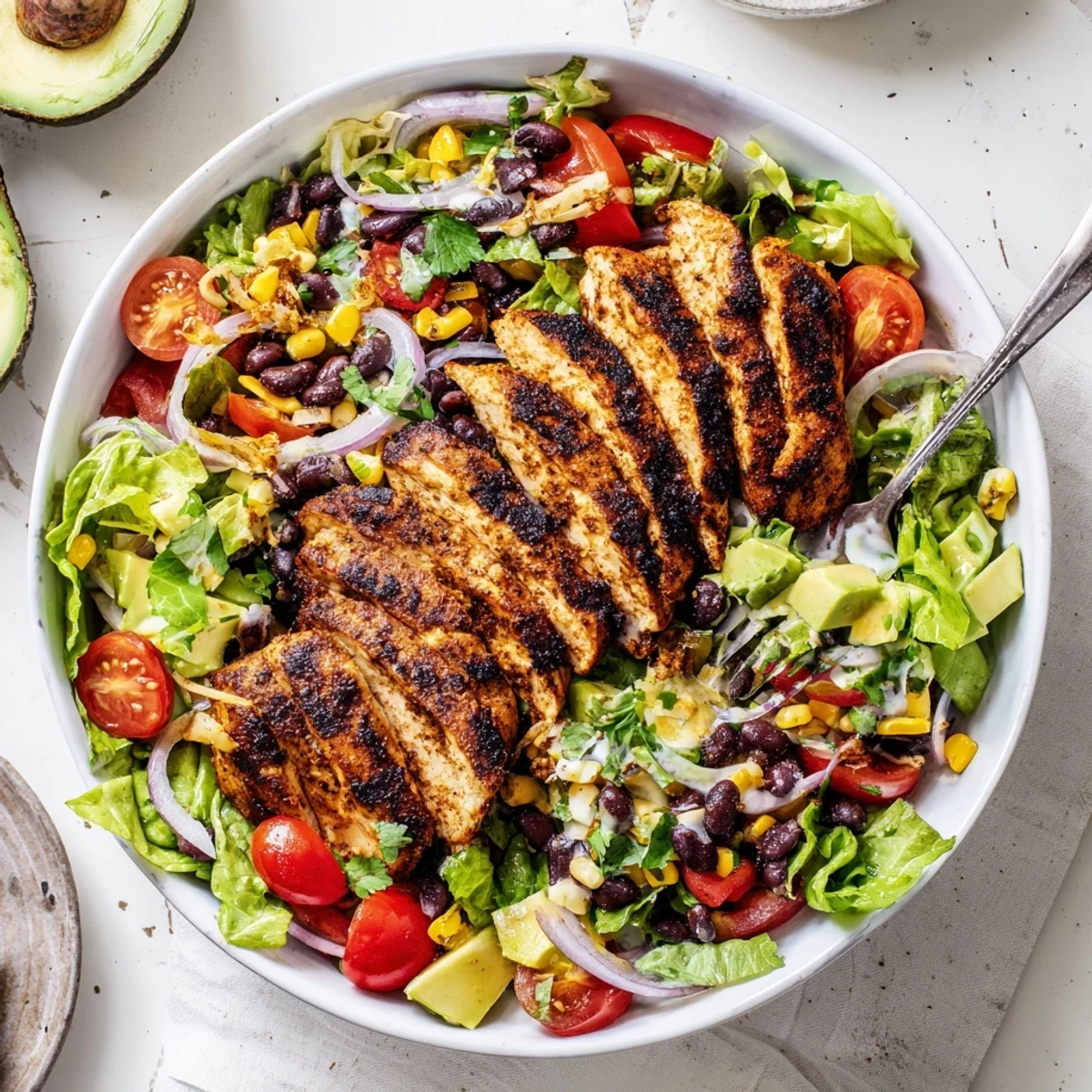 Grilled Southwestern Chicken Salad with charred breast slices, roasted corn, creamy avocado