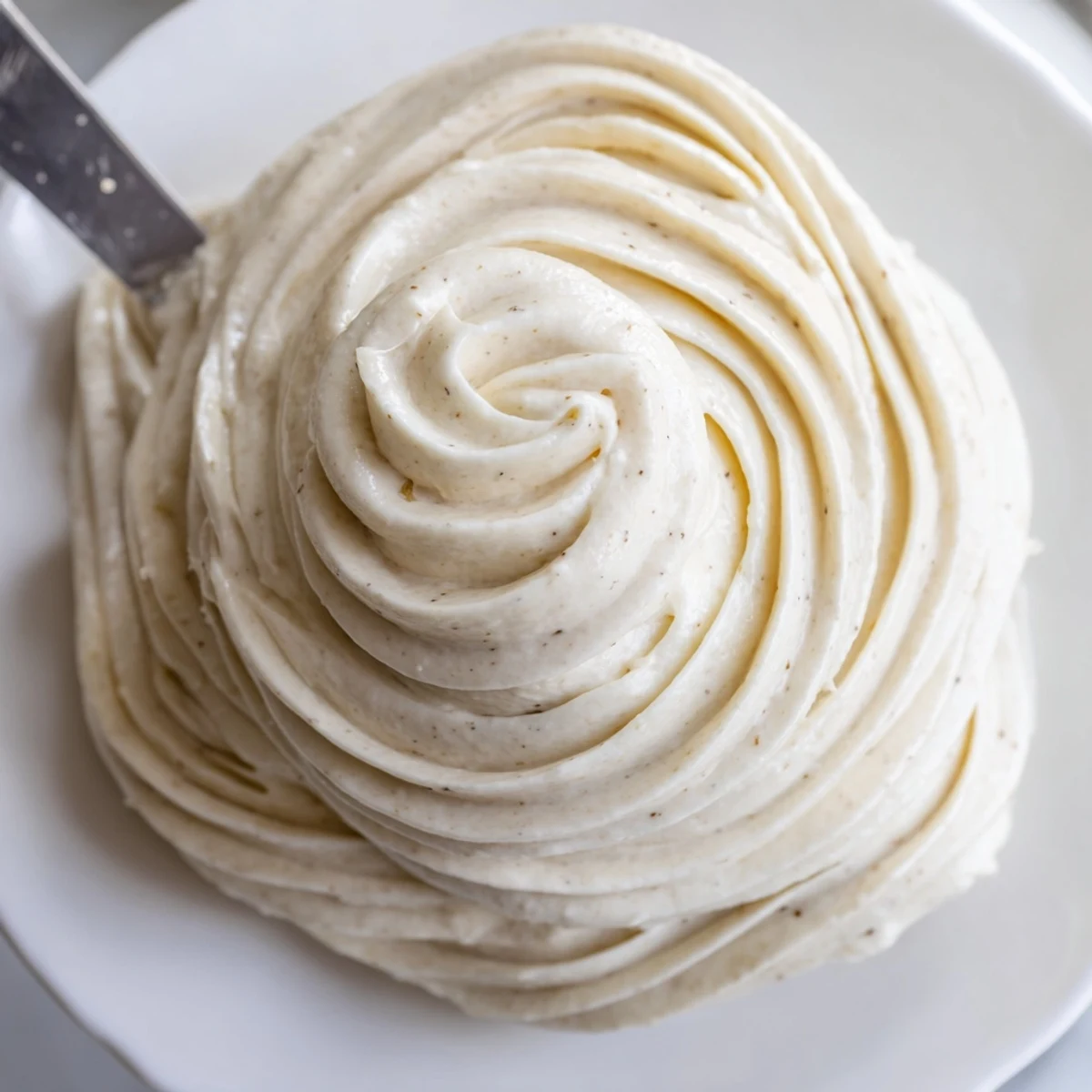 Creamy Italian meringue buttercream swirled atop a golden layer cake