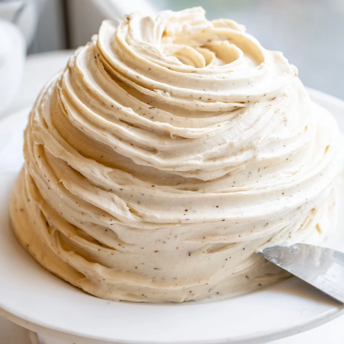 Fluffy Italian meringue buttercream piped into elegant rosettes on dessert