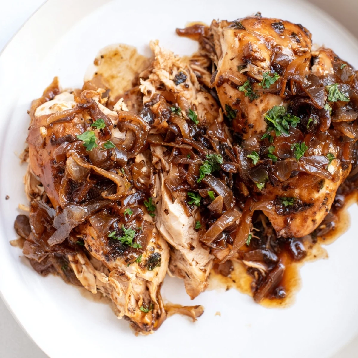 Slow Cooker Balsamic Chicken garnished with fresh parsley served over creamy mashed potatoes