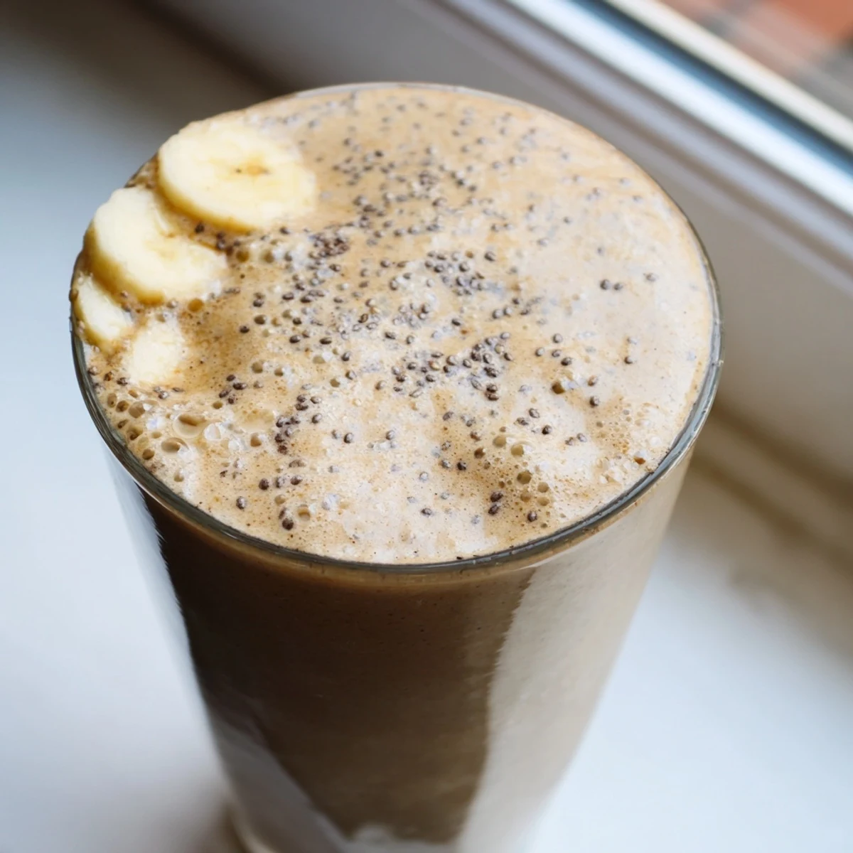 Chilled banana protein coffee smoothie blended smooth and served fresh in a mason jar