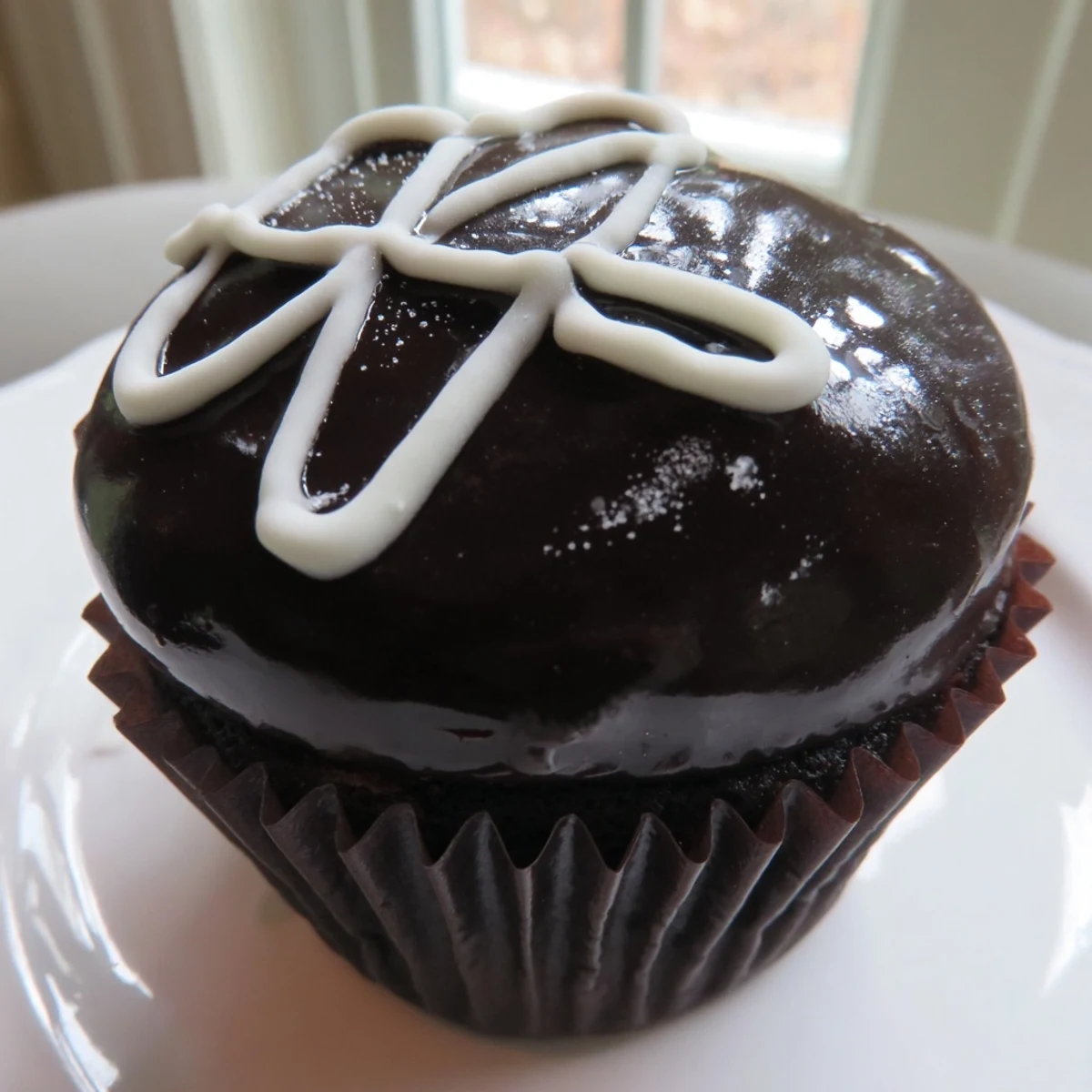 Rich Homemade Hostess Cupcakes sliced open to reveal fluffy marshmallow filling inside