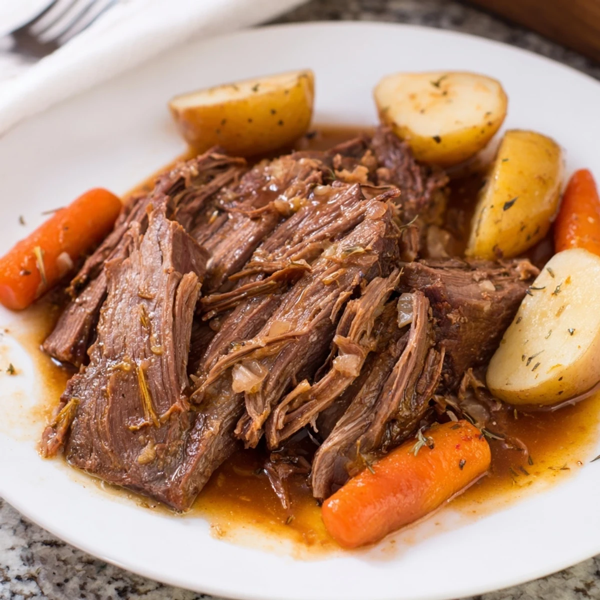 Perfect pot roast with tender pull-apart beef and golden root vegetables in rich herb gravy