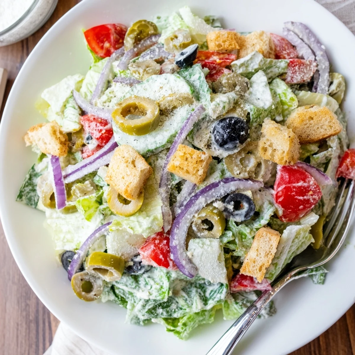 Crisp Olive Garden Salad topped with croutons, pepperoncini, and creamy Parmesan dressing